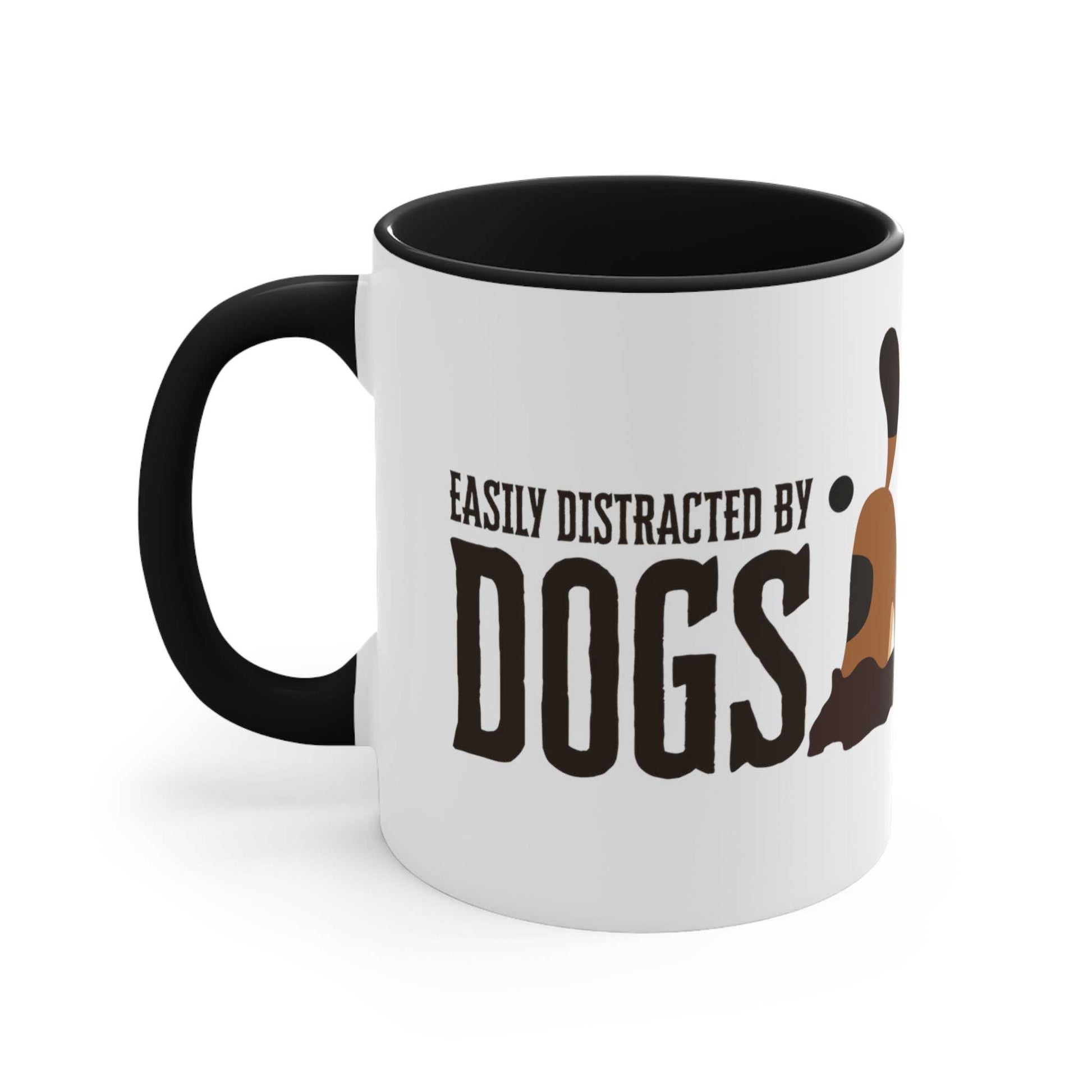 A Dogs Pure Love ceramic mug with a black inner and handle, contrasted with a white outer spotlights the slogan 'Easily Distracted by Dogs,' and dog digging graphic, against a white backdrop.