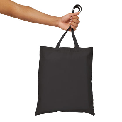 Against a white background, an extended arm holds a Dogs Pure Love tote bag, revealing the back of the bag with no print.