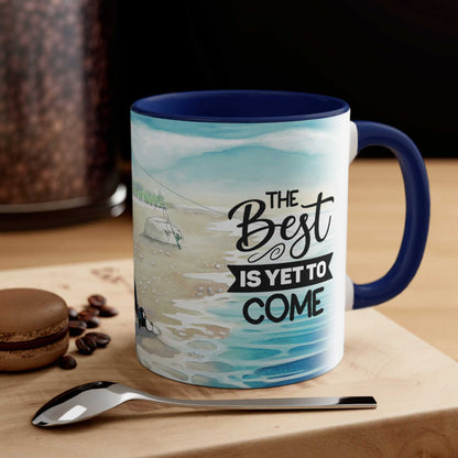  A Dogs Pure Love two-toned ceramic mug, showcasing a blue inner and handle, and outer illustration with text 'The best is yet to come,' sits on a table accompanied by a biscuit, spoon, and coffee beans.