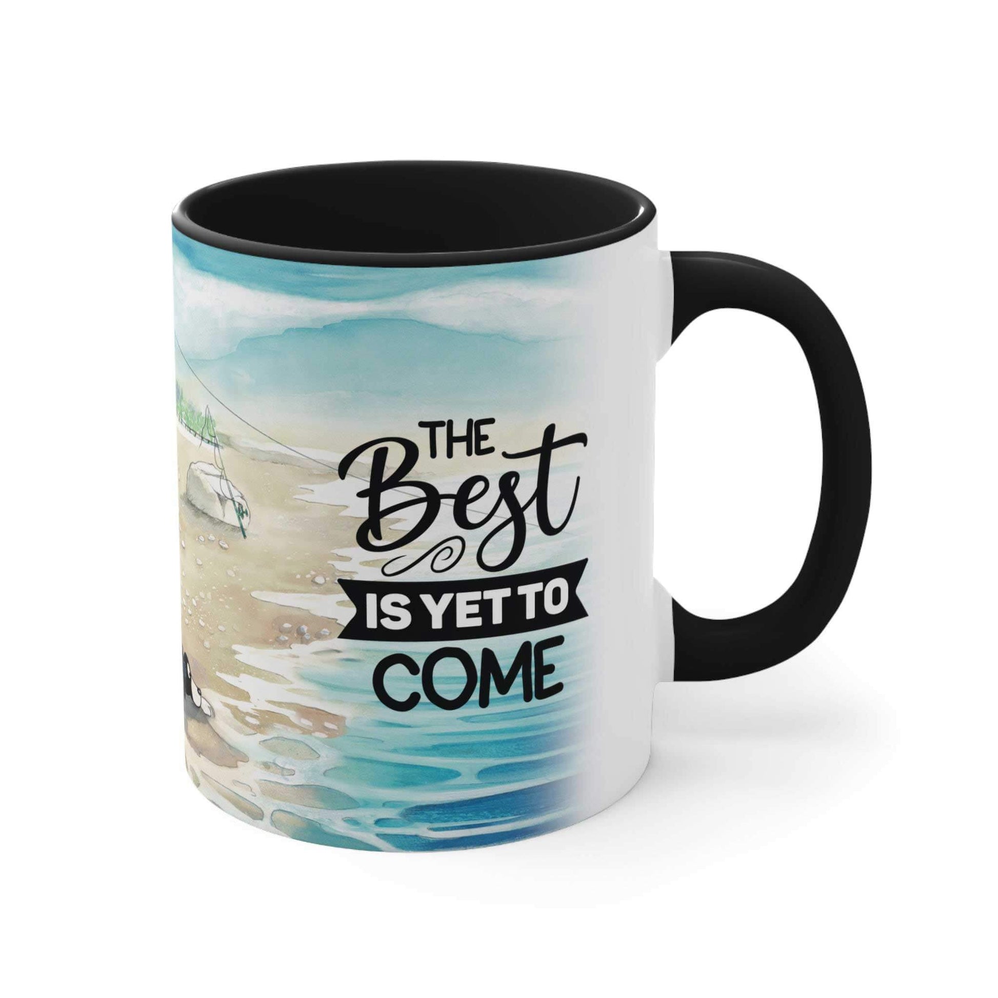  A ceramic two-toned mug from Dogs Pure Love showcases a black inner and handle, with a white outer surface featuring an illustration displaying the words 'The best is yet to come,' set against a white backdrop.