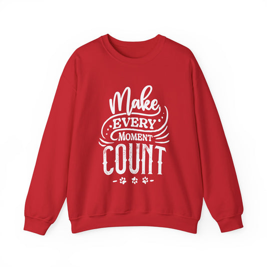  Against a white backdrop, a Dogs Pure Love red unisex sweatshirt showcases the slogan 'Make Every Moment Count.'