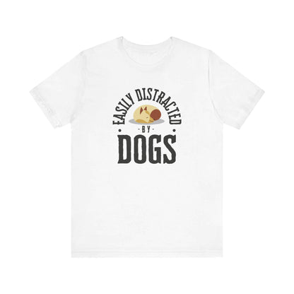  A Dogs Pure Love 'Easily Distracted by Dogs' white unisex t-shirt, featuring text and graphics, rests against a plain white backdrop.