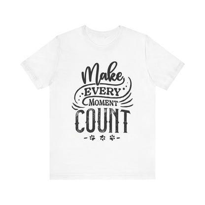 A white Dogs Pure Love unisex t-shirt highlights the words 'Make Every Moment Count,' against a white backdrop.