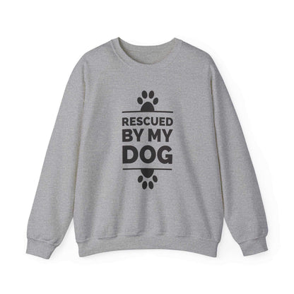  Presenting a Dogs Pure Love sport grey unisex sweatshirt embellished with paw prints and the empowering text 'Rescued by my Dog,' displayed against a pristine white background.