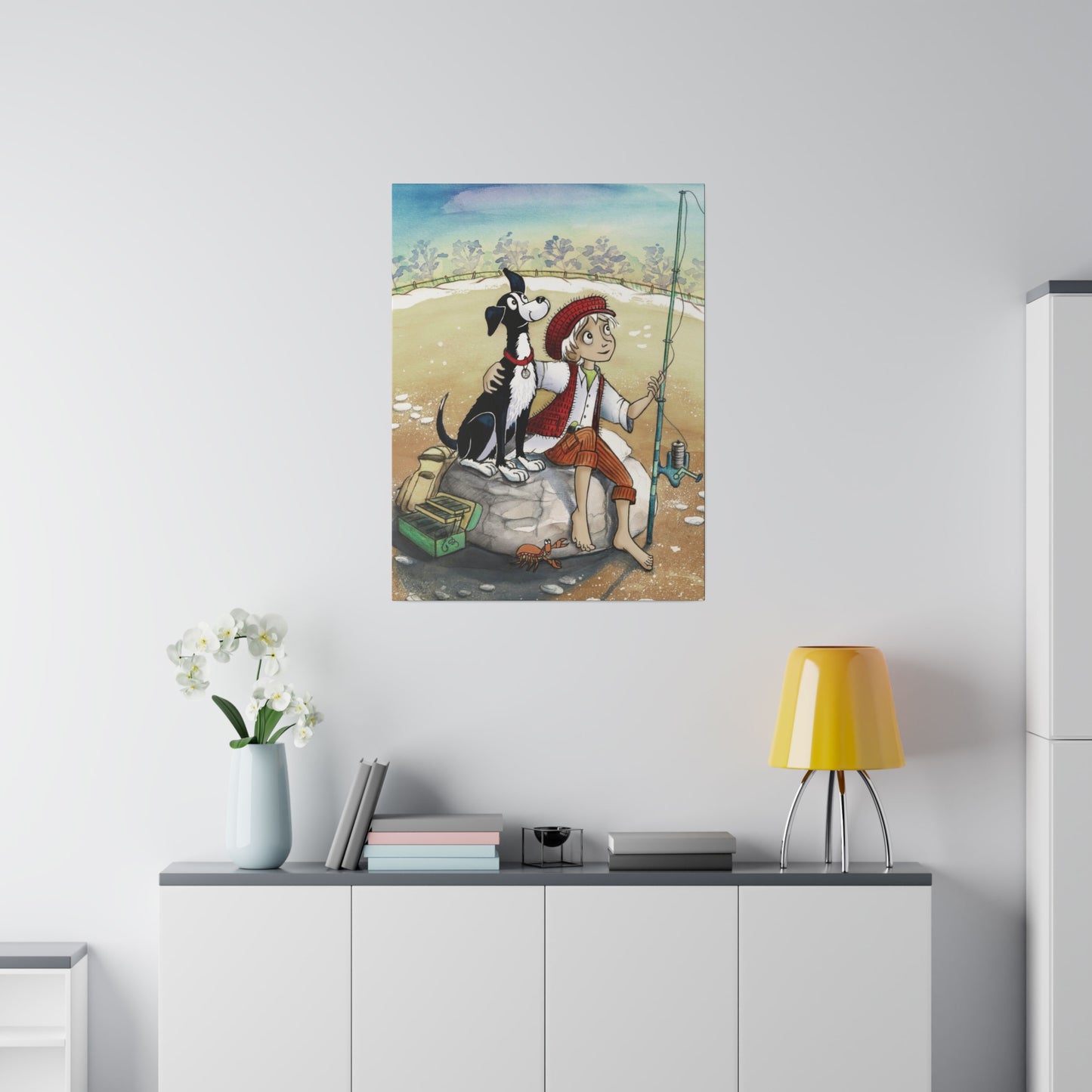 A 18" x 24" 'Dogs Pure Love Fishing' canvas hangs on a wall, above a narrow cabinet, which features a yellow lamp, books, and a vase of flowers.