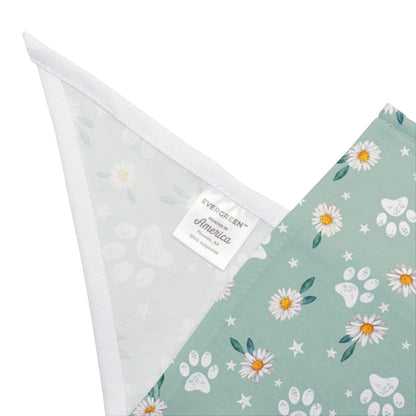 The Dogs Pure Love bandana is folded in half to show a label, which reads printed in America. 