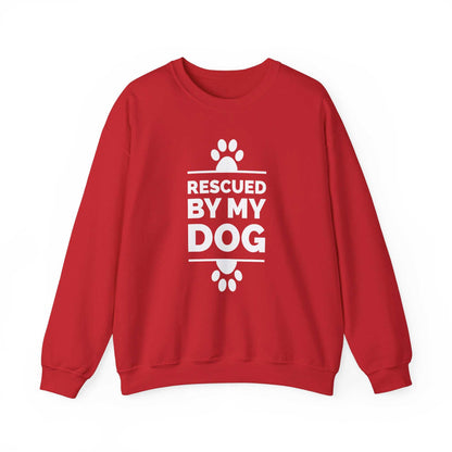  Introducing a Dogs Pure Love red unisex sweatshirt adorned with paw prints and the text 'Rescued by my Dog,' showcased against a clean white backdrop.