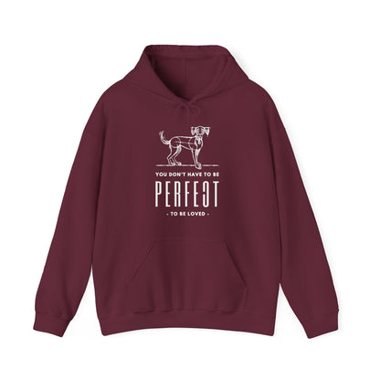  Dogs Pure Love unveils a maroon colored unisex hoodie adorned with a sketch of a dog and the printed text 'You don't have to be perfect to be loved,' all set against a white background.