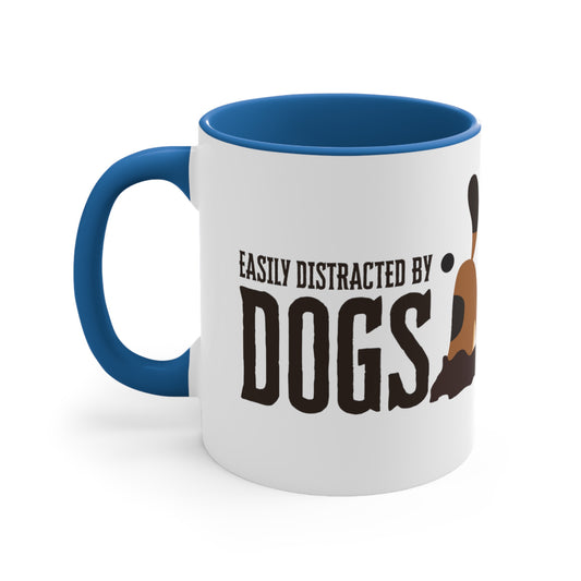 A Dogs Pure Love ceramic mug with a blue inner and handle, and white outer, features the slogan, 'Easily Distracted by Dogs,' and dog digging graphic, against a white backdrop.