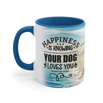 Set against a white background, a Dogs Pure Love ceramic mug with a blue inner and handle, and a white outer of a beach illustration, showcases the slogan "Happiness is knowing your dog loves you no matter what." 