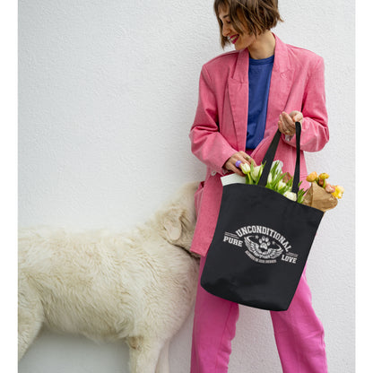  A woman carries a Dogs Pure Love canvas tote bag filled with tulips, glancing to her side where a white dog peeks out from behind her against a white wall.