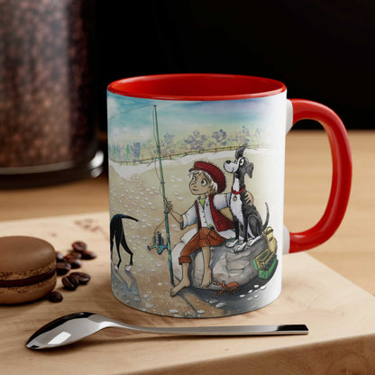  A Dogs Pure Love ceramic mug, showcasing an illustration of a boy and dog fishing on its exterior, with a striking red interior, is placed on a wooden table alongside a spoon, biscuit, and scattered coffee beans.