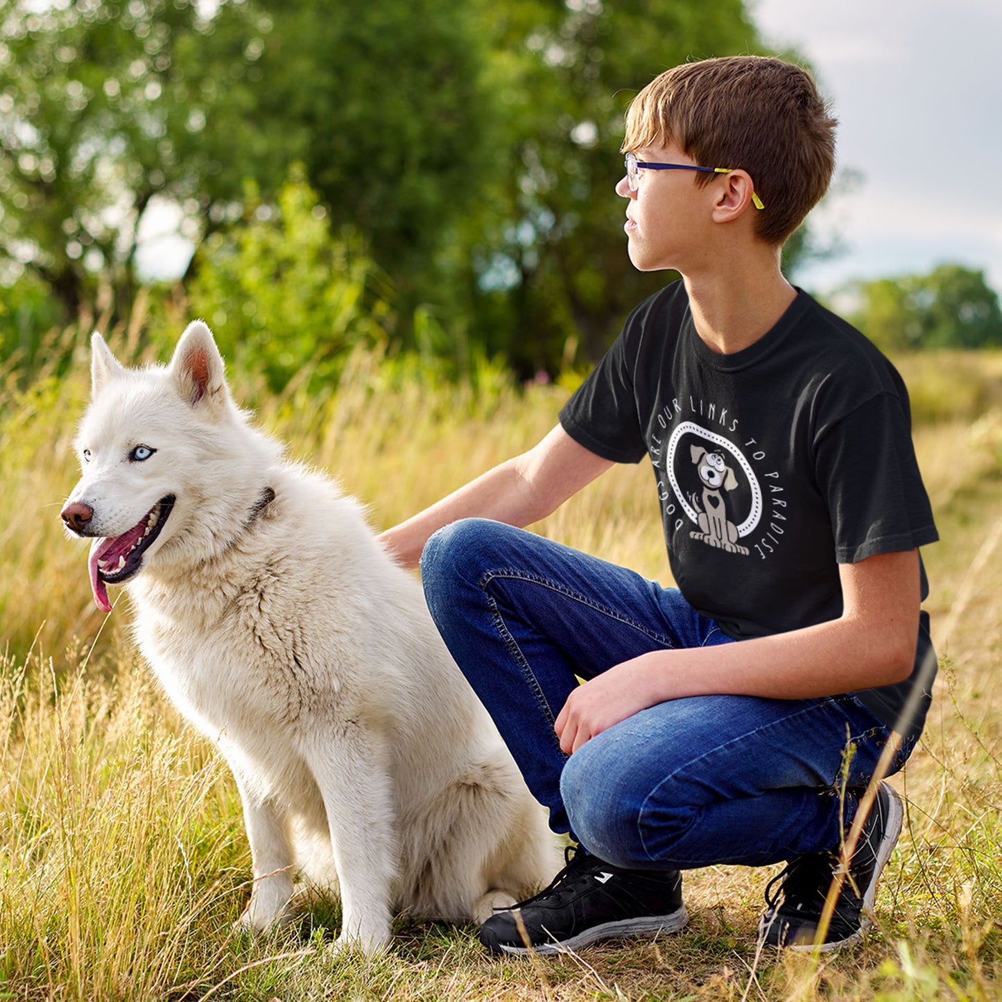  A young boy crouches next to his Husky, sporting a black Dogs Pure Love 'Paradise Is' tee.