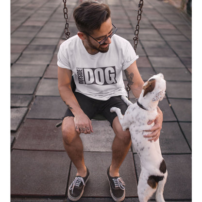 A man sits on a swing, clad in the Dogs Pure Love 'Outside Dog' tee, affectionately pats his Jack Russell. The dog stands upright, its paws resting on the man's leg, with its back turned to the camera.
