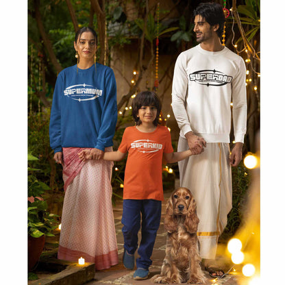 A mother, father and child stand near their dog in an outside courtyard wearing Dogs Pure Love sweatshirts.