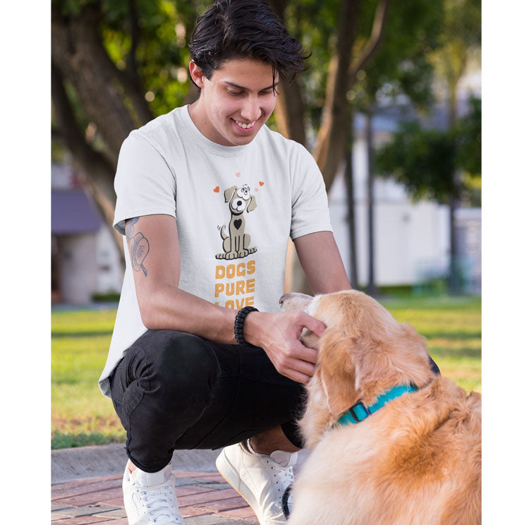 In a park, a man clad in a 'Dogs Pure Love' unisex tee crouches down, gently patting the face of his Golden Retriever, whose back is turned to the camera.